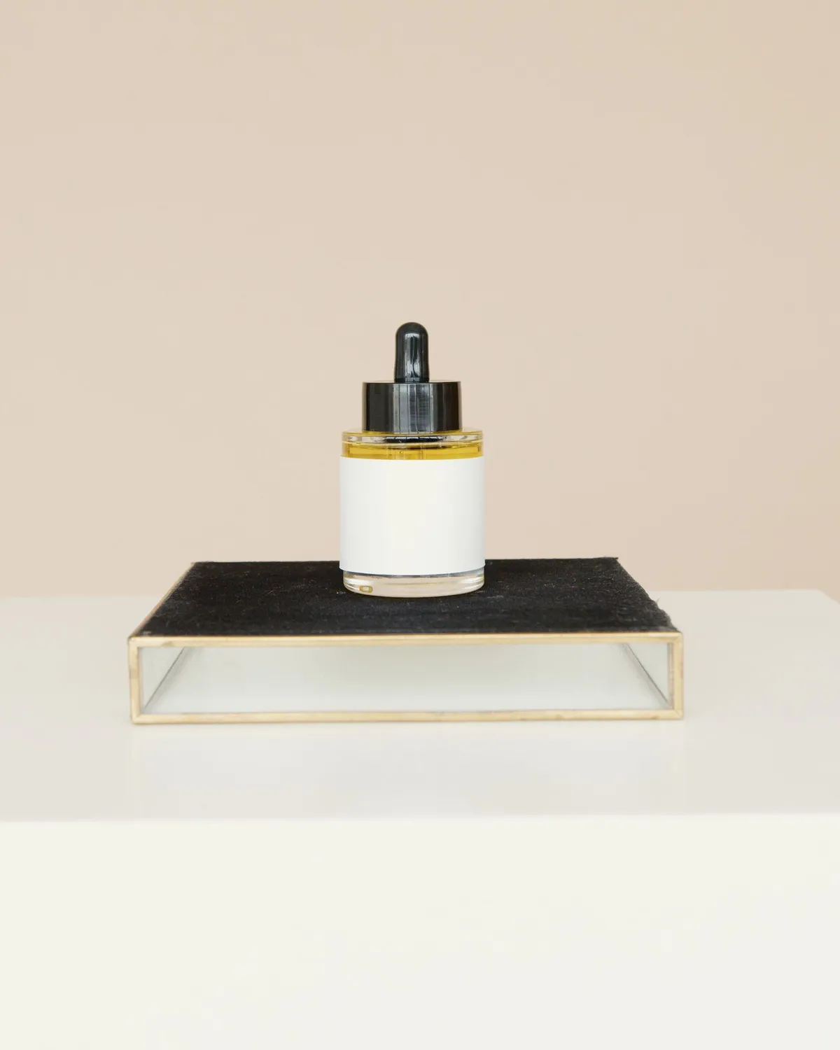 small glass dropper bottle of facial essence