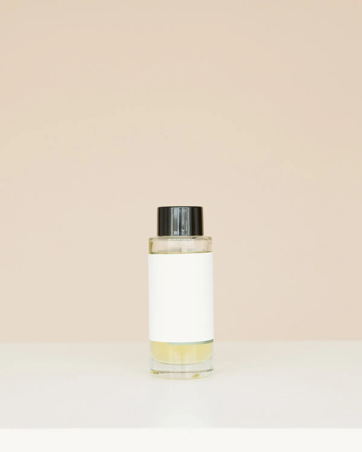 clear glass bottle of facial toner with black cap